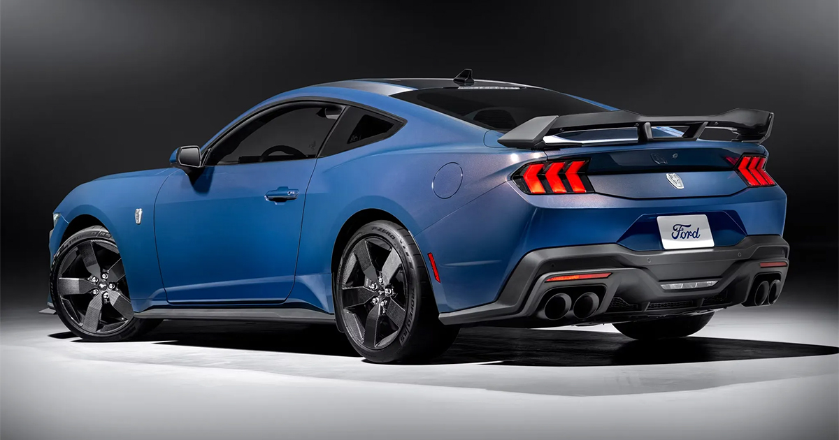Blue Ford Mustang Dark Horse performance coupe with sleek body lines and aggressive rear spoiler, rear view