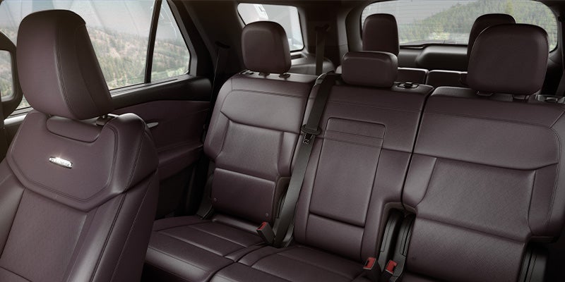 The dark purple leather second and third-row seats inside a Ford Explorer SUV.