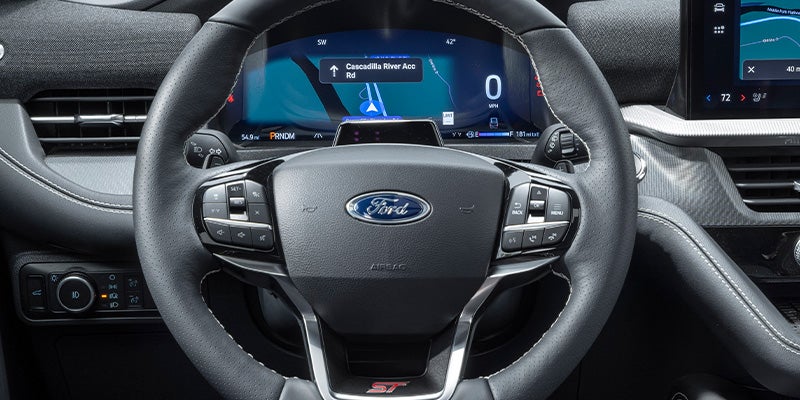 The steering wheel and digital instrument cluster of a Ford Mustang Mach-E GT with navigation on
